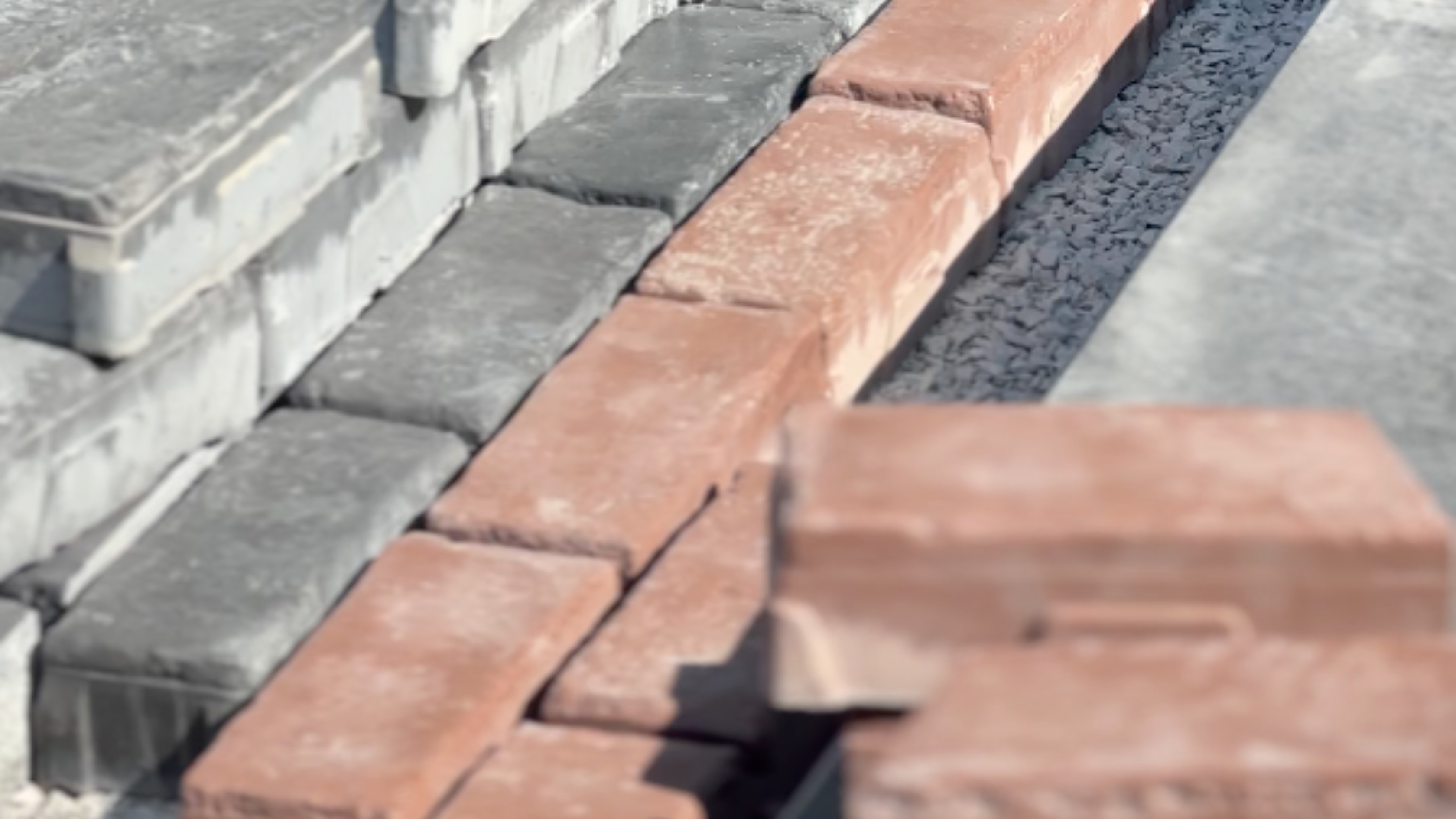 Close-up of brick soldier course border detail along paver driveway edge
